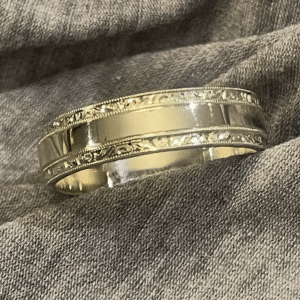 Art Deco men’s wedding band in white unplated 18K gold with high polish finish and hand-engraved side stripes, 6mm width.