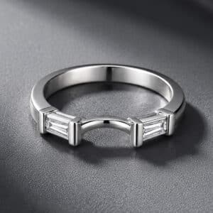 14K gold curved nesting band with two tapered baguette diamonds designed to fit around an engagement ring.