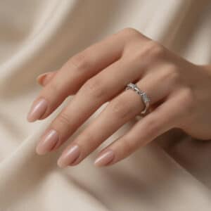 Curved gold ring enhancer with two tapered baguette diamonds crafted to complement an engagement ring.