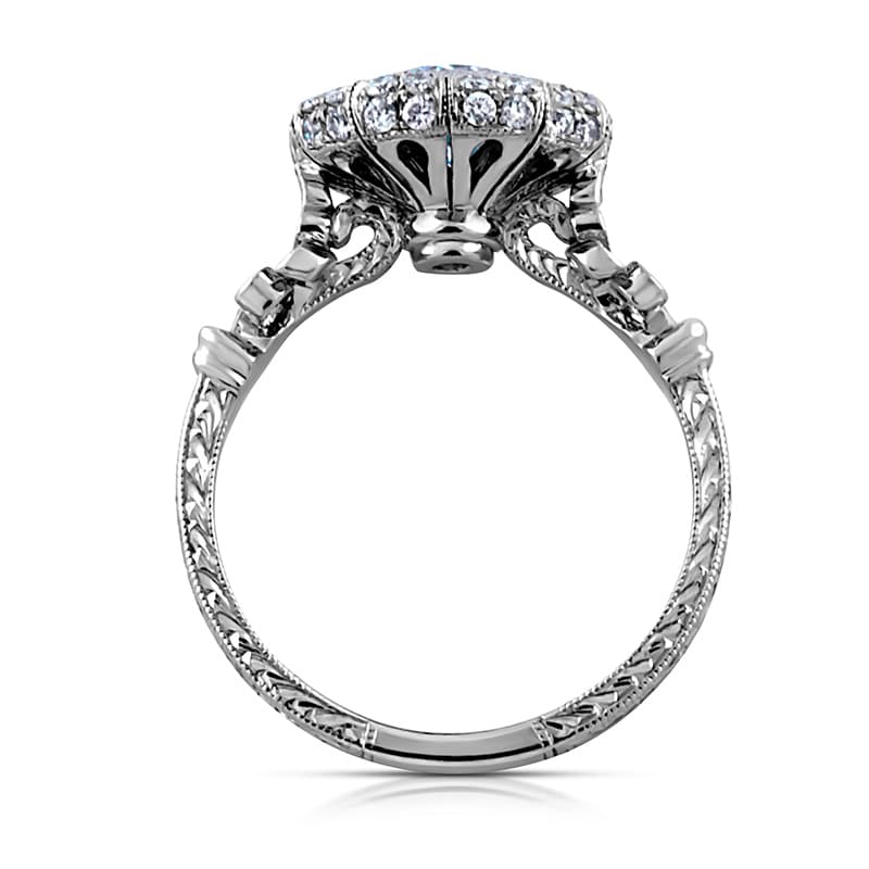 Antique engagement ring with vintage-style details and center diamond.