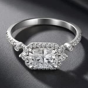 East-west radiant cut lab-grown diamond engagement ring with a diamond halo and split shank in white gold.