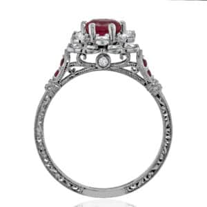 Handcrafted ruby and diamond engagement ring with floral motif, hidden diamond accents, and polished finish.