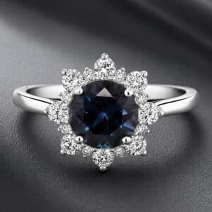 Modern alexandrite engagement ring featuring a 2ct color-changing lab-created alexandrite surrounded by a natural diamond halo.