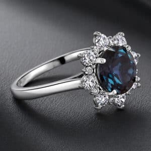 Side profile of a color-changing alexandrite ring with natural diamonds and a polished modern setting.