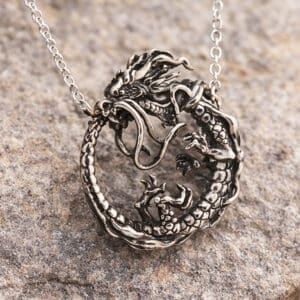 Ouroboros dragon pendant symbolizing eternity, unity and transformation in detailed vintage style