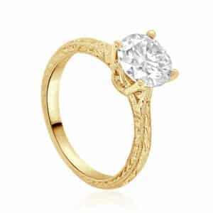 Close-up of vintage solitaire diamond ring with secure 4-prong setting in 18K gold