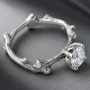 White gold branch engagement ring with round lab diamond center and natural diamond accents set into organic twig details.