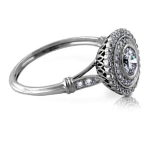 Leaf-ended shank with burnish-set natural diamond accents on a platinum Double Halo Art Deco diamond ring; hand-engraved vintage filigree with lab-grown round center.