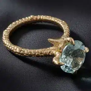 Unique eagle claw aquamarine ring featuring a 10mm round aquamarine held by sculpted eagle talons in solid 14K white gold.
