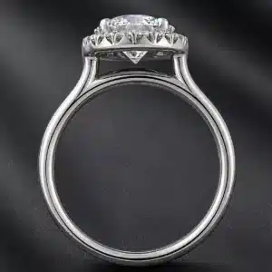 Flush-fit halo engagement ring with a round center diamond and smooth straight shank designed to pair with wedding bands.