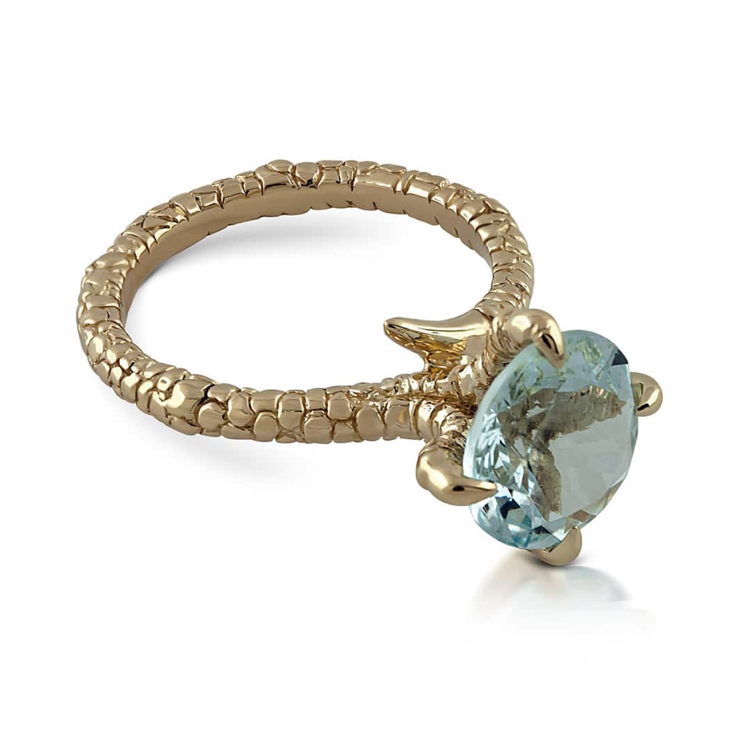 Nature-inspired animal claw ring in white gold featuring a large round aquamarine held by detailed eagle talons.