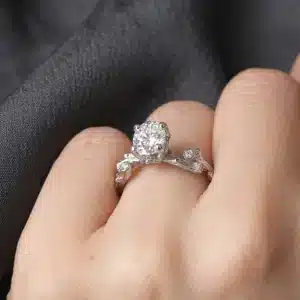 Rustic twig style engagement ring with round lab-grown diamond, natural accent diamonds, and handcrafted white gold branch band.