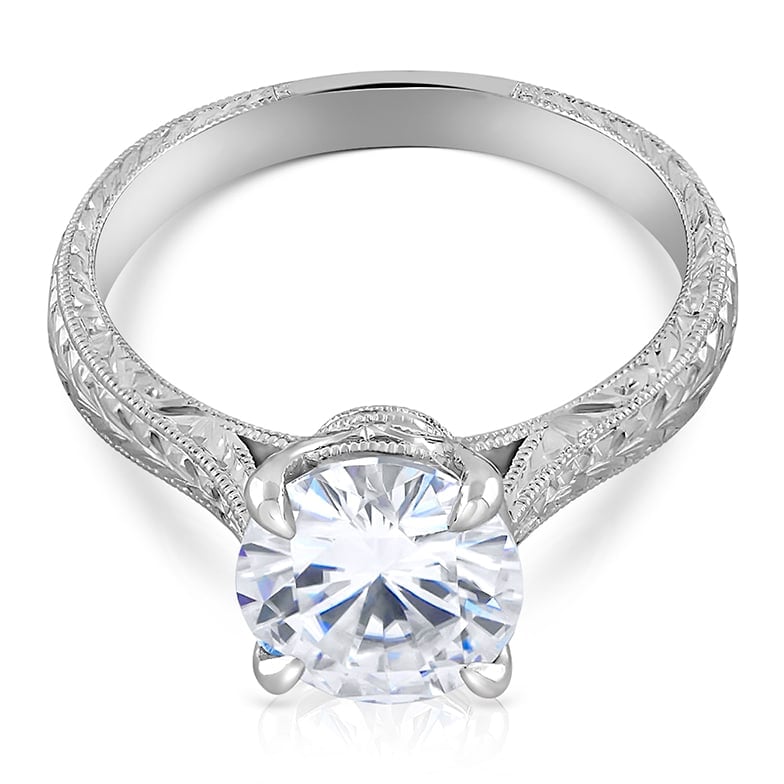 Vintage solitaire diamond ring with hand-engraved band and classic setting in gold