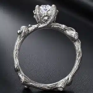 Woodland inspired engagement ring with textured tree branch band and elevated round lab-grown diamond center stone.