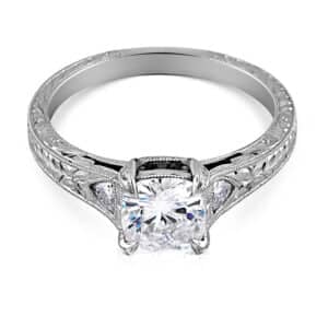 Vintage cushion cut diamond ring with trillion side stones and hand engraving by OroSpot.