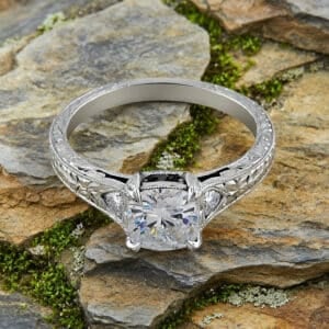 antique hand engraved cushion cut diamond engagement ring with vintage detailing, milgrain edges and side stones in white gold by orospot