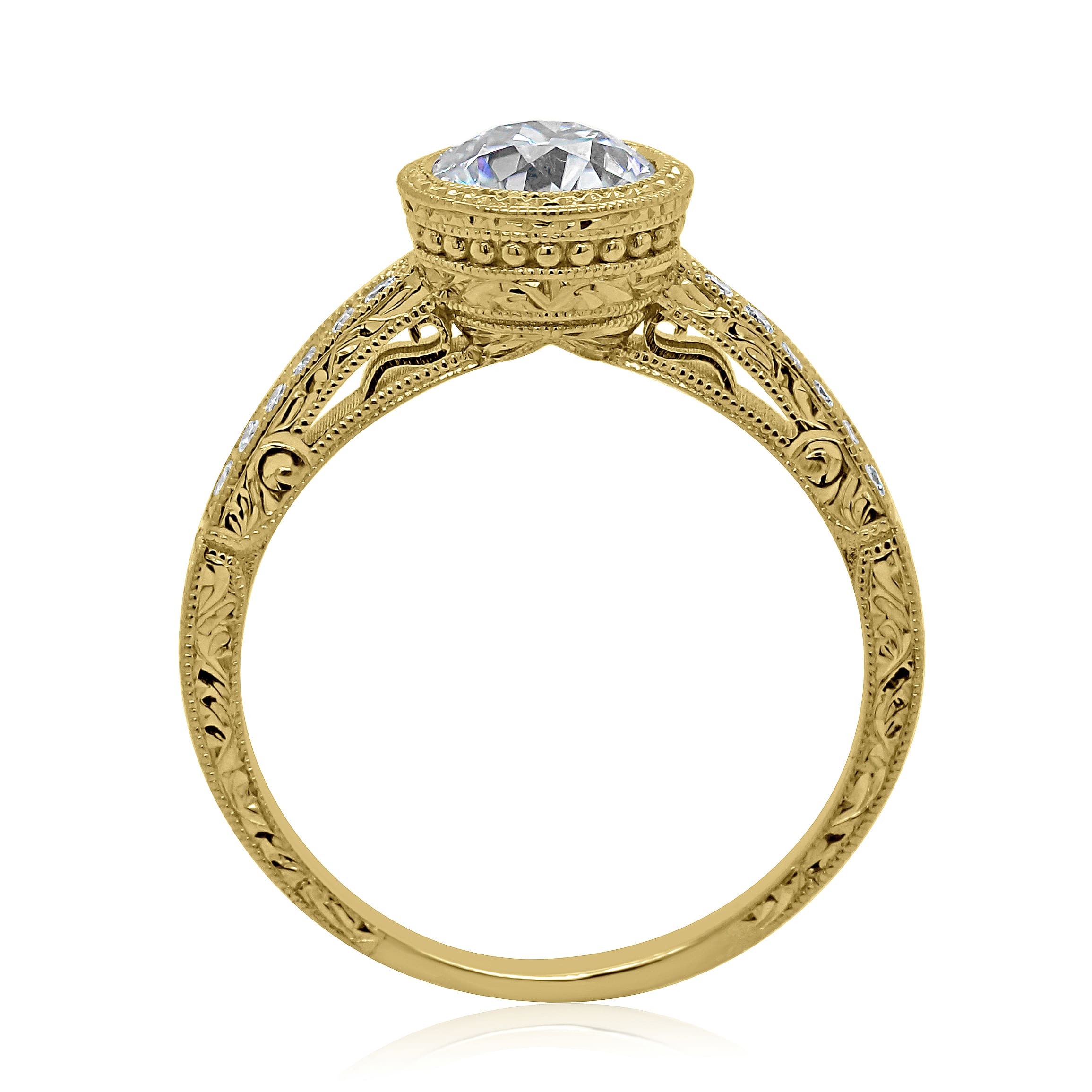 Art Deco diamond engagement ring with hand engraving, bezel-set round center diamond, and pavé side stones in yellow gold.