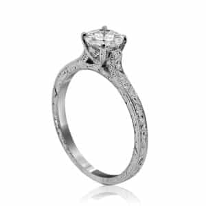 Cathedral-style vintage solitaire diamond ring with hand-engraved details
