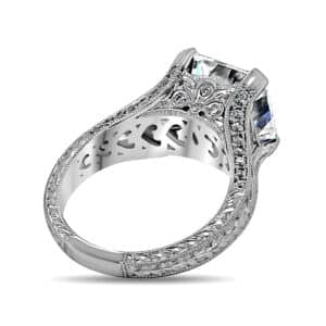 Vintage-style Asscher and trillion cut diamond ring with pavé accents, hand engraving, and Art Deco filigree detailing.