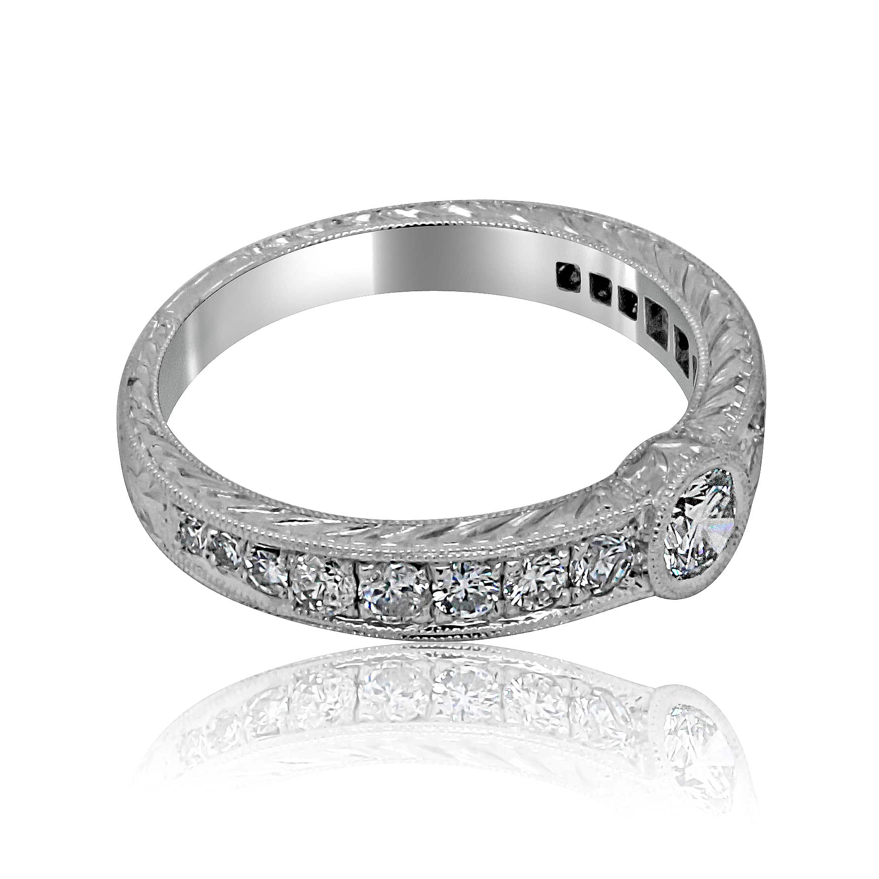 Antique-style low-profile bezel engagement ring with vintage hand engraving and Art Deco design details