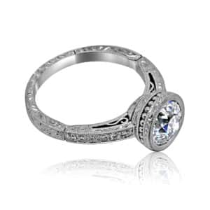 platinum art deco bezel engagement ring with hand engraving and pavé side diamonds, featuring a 6.5mm round lab diamond
