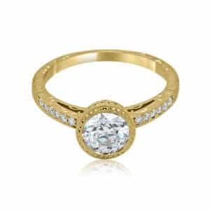 Unique Art Deco diamond engagement ring with hand engraving, bezel setting, and vintage-inspired details.