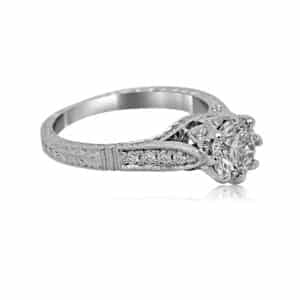 Eight-prong crown engagement ring with hand-carved band and diamond center, vintage-style in gold or platinum.