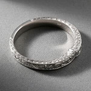 Vintage chevron curved wedding band with hand engraving, milgrain edges, and elegant V-shaped contour.