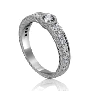 Unique Art Deco engagement ring with hand engraving, low-profile bezel setting, and vintage antique-inspired design