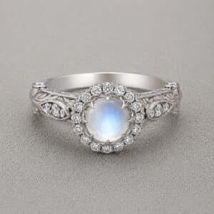Vintage cabochon moonstone and diamond ring with hand engraved band and milgrain detail in 14k white gold by OroSpot