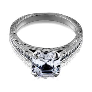 Antique-style engagement ring with Asscher cut setting, cathedral design, and hand engraving in white gold