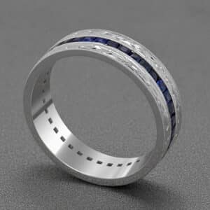 blue sapphire mens eternity band white gold channel setting engraved sides milgrain detail orospot