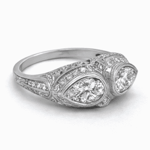 platinum double pear shape vintage diamond ring with milgrain engraving and pavé accents