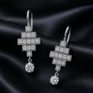 Art Deco style white gold drop earrings with geometric diamond tops and 5mm round lab diamond drops.