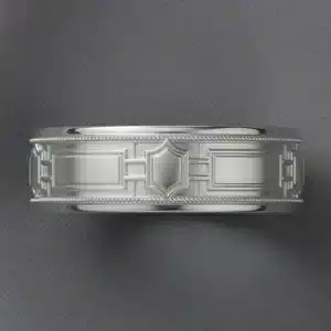 Top-angle view of an Art Deco men's wedding band featuring geometric architecture-inspired detailing and milgrain borders.