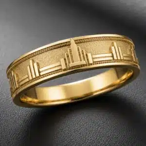 Yellow gold men's wedding band featuring a three-dimensional architectural relief pattern inspired by Chicago Art Deco skyscrapers, geometric cityscape elements, and fine textured detailing.