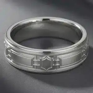 Architectural men's wedding band with geometric Art Deco panels and symbolic keystone centerpiece in white gold.