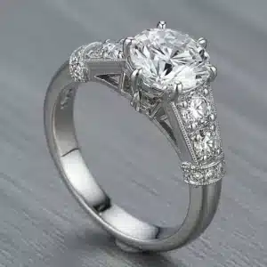 Vintage-style platinum engagement ring with GIA-certified 1.57ct H VS2 round diamond and 0.62ct total weight side diamonds.