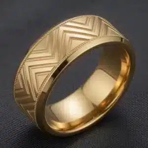 Bold men's geometric chevron wedding band in 14K yellow gold with milgrain borders.