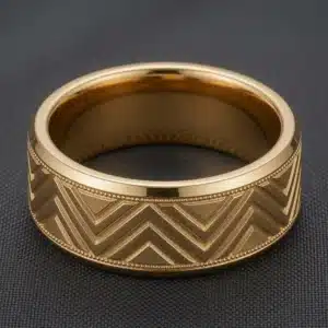 Side view of masculine 14K yellow gold chevron men's wedding band with milgrain edges