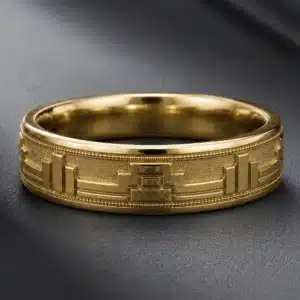 6mm men's New York Art Deco wedding band featuring a geometric keystone motif, architectural detailing, and fine milgrain edges in yellow gold.