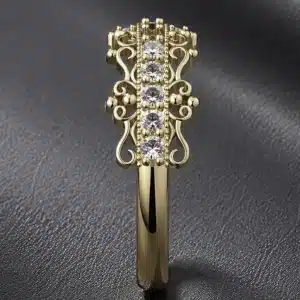 14k yellow gold vintage diamond half eternity band worn on a woman's hand with intricate filigree details